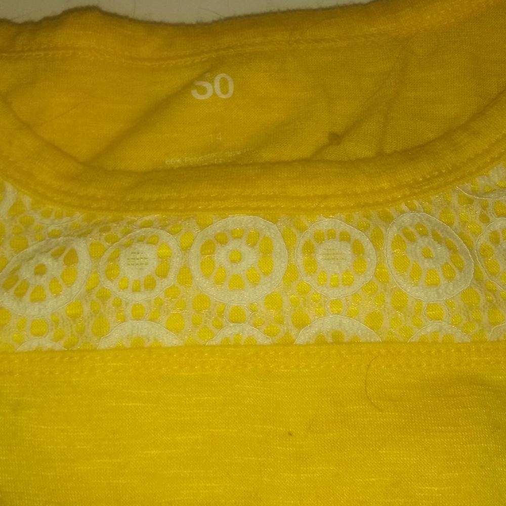 A yellow shirt with showing sholders